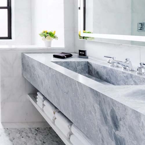 Marble lavatory vanity and basin in hotel bathroom