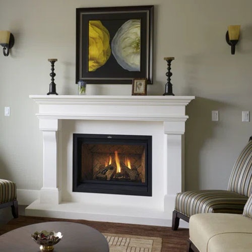 white limestone french design fireplace mantel with a broad mantel shelf