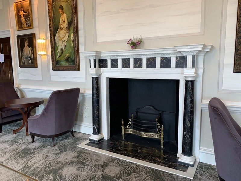 A statuary and Porto marble columned neo-classical chimneypiece 