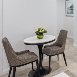 Dining table and upholstered chair in Meriton Suites Sydney