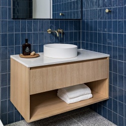 Floating bath vanities with wood tone vanity base and white artificial stone surface