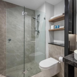 Hinged glass shower enclosure in Meriton Suites Sydney