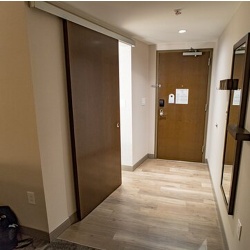 Hotel Bathroom Barn Door with Stained Wood Pattern