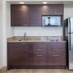 Hotel kitchenette with granite countertop and sink