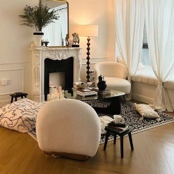 Interior Furnishing with Marble Fireplace Mantel and Upholstered Lounge Chair