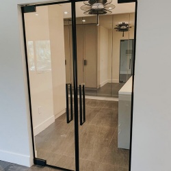 Interior door with clear glass and matte black hardware