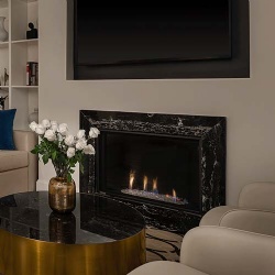 Marble bolection moulding surround for gas fireplace in boutique hotel room