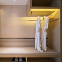 Open Closet with Luggage Bench in Hotel Guestroom