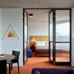 Room dividing wall by glass door and partition in ACE hotel room