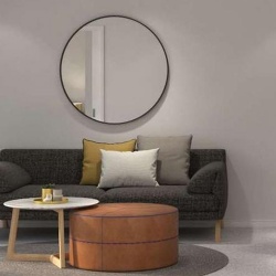 Round metal framed mirror above sofa