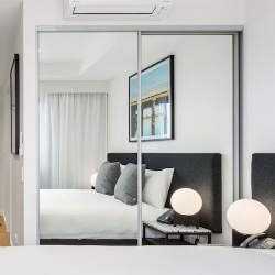 Sliding closet door with glass mirror in Questa apartment Perth