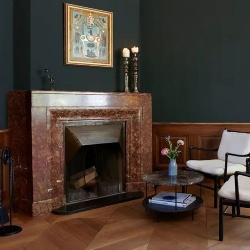 The red marble fireplace in the Signau House and Garden