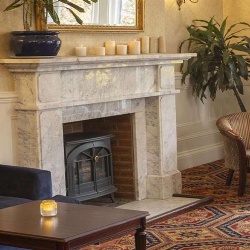 UK Hotel Brands Featuring Marble Fireplace Mantels in Guest Rooms