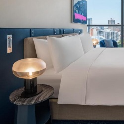 Upholstered headboard and nightstand with marble surface in W hotel room