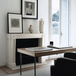 White marble fireplace mantel in office