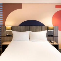 Wooden panel headboard for IBIS hotel room