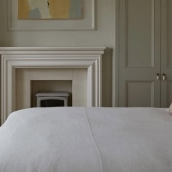 sleek bolection style limestone fireplace surround for guest bedroom